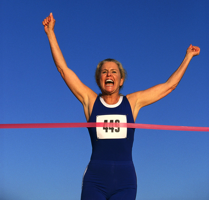 Runner Crossing the Red Tape at the Finish Line